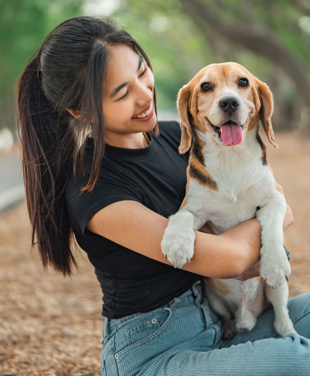 Smiling Girl Holding Beagle