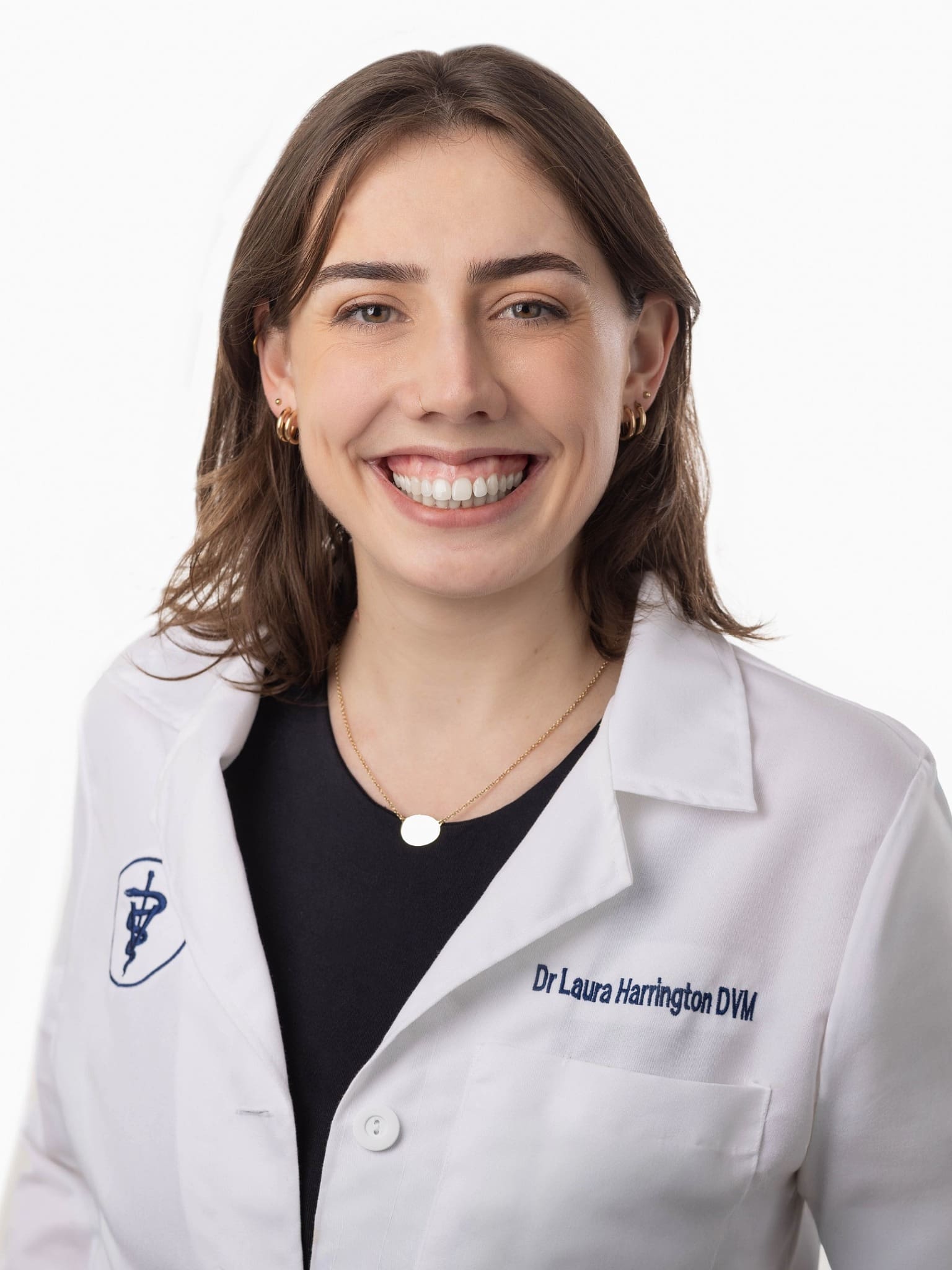 Dr. Laura Harrington - female with shoulder length brown hear wearing a veterinarian lab coat