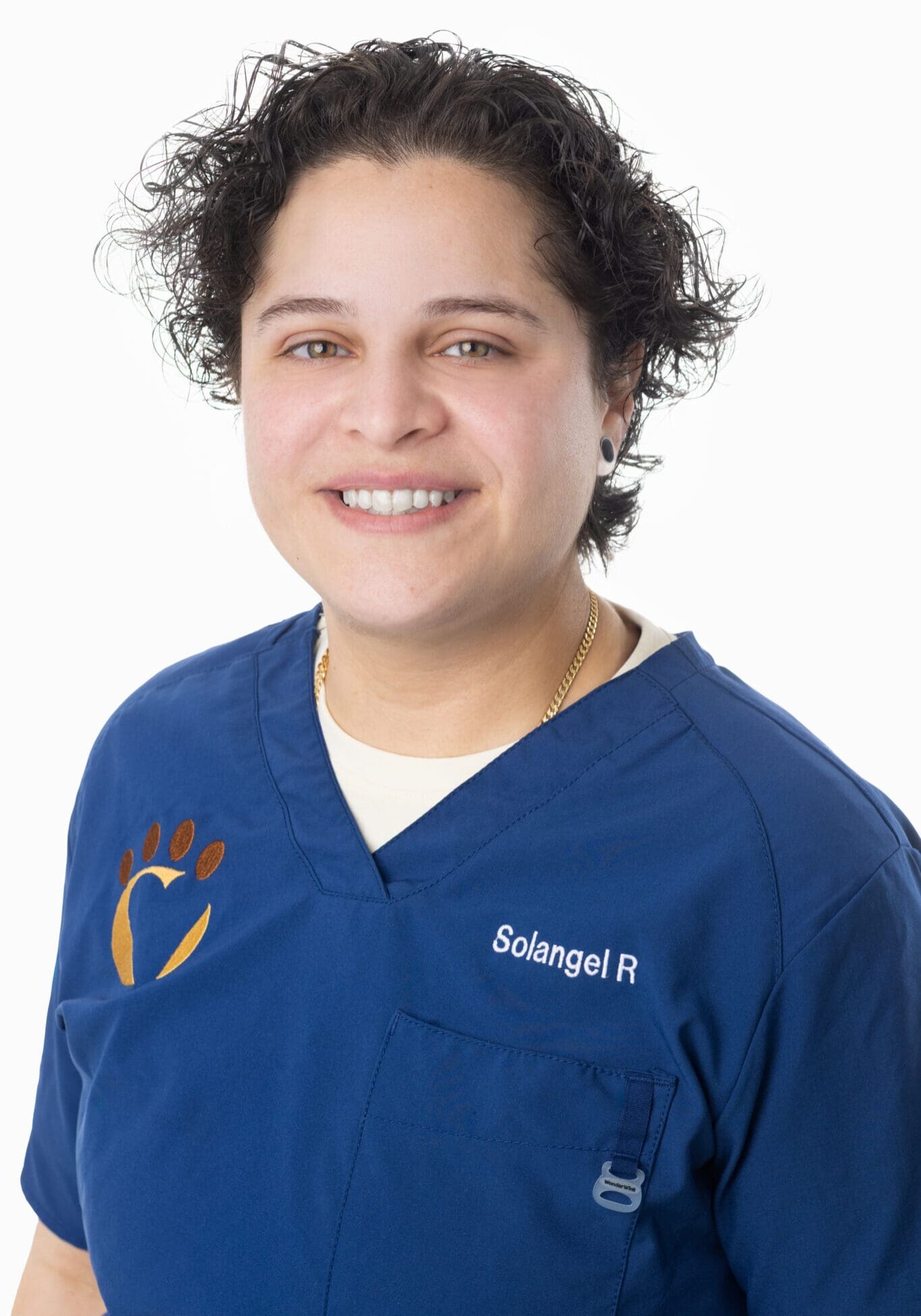 Sol veterinary assistant Sol smiling in blue scrubs